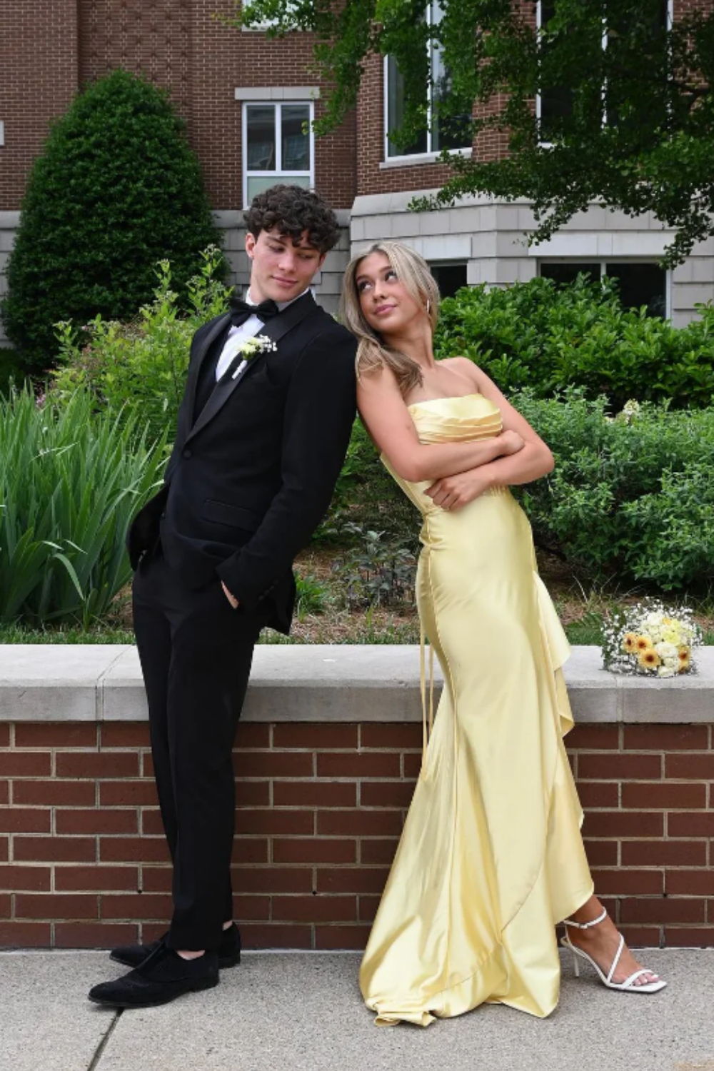 Yellow satin A-line prom dress featuring a trendy cowl neckline, ruched waist detailing, and a high side leg slit.