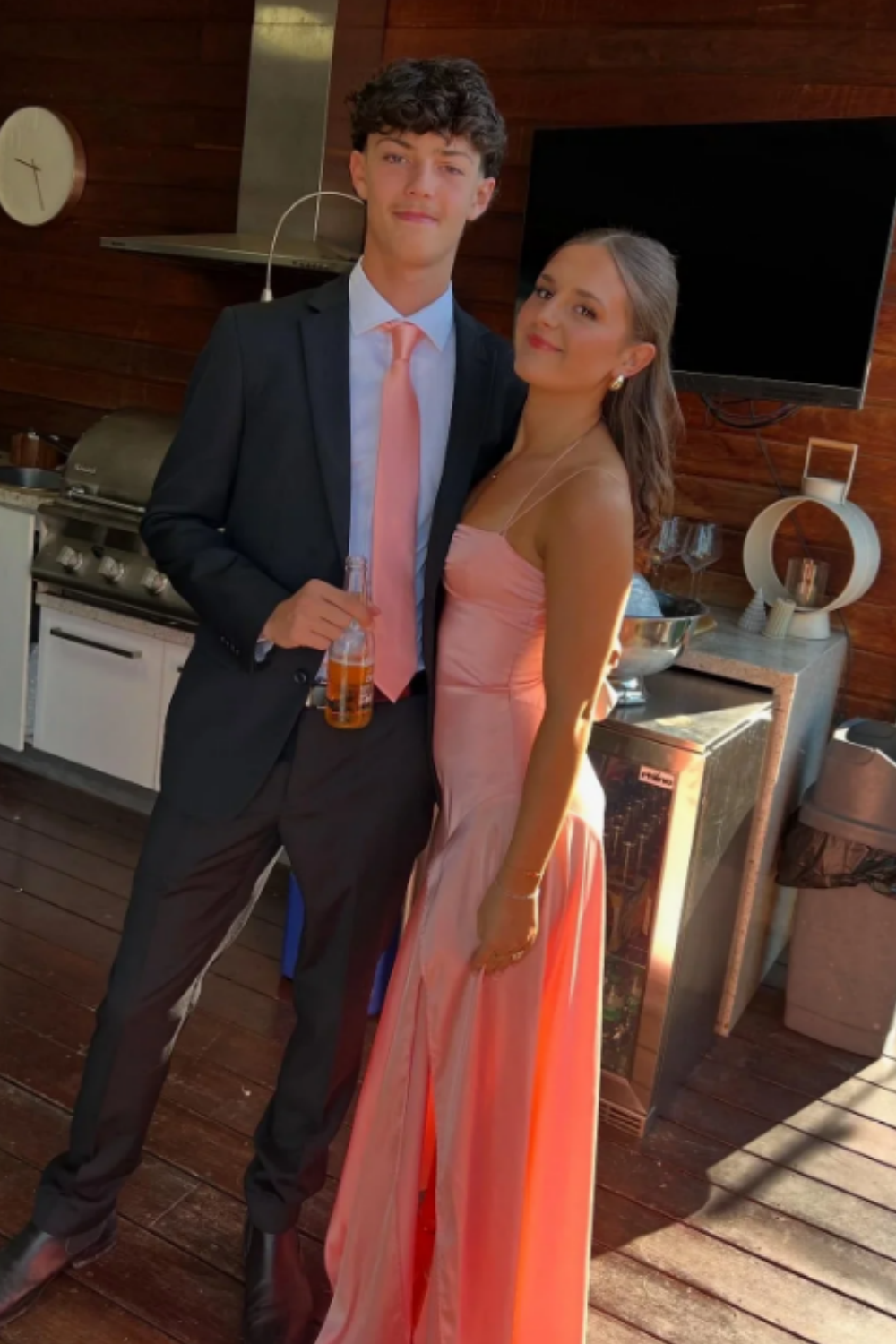 Pink long formal mermaid dress featuring double spaghetti straps, a ruched bodice, and a high side leg slit.