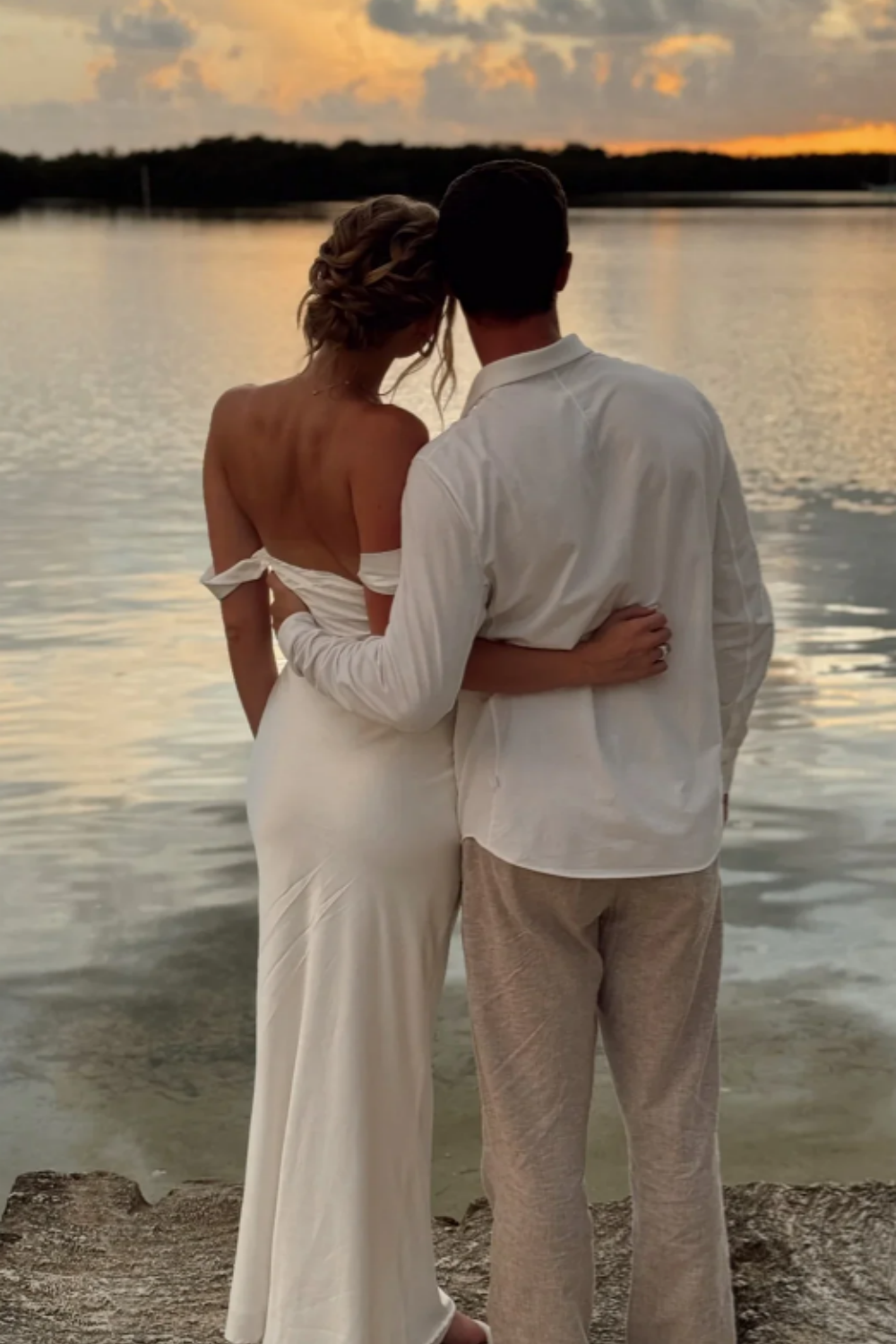long formal gown featuring an off-the-shoulder neckline, fitted mermaid silhouette, and elegant ruched detailing.