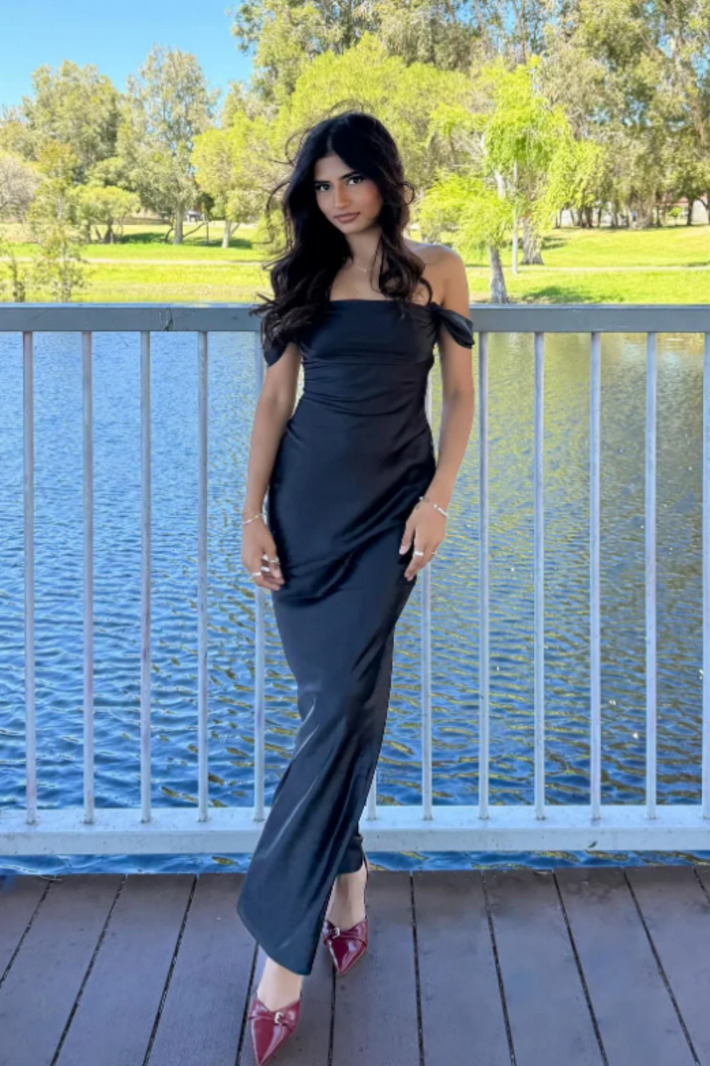 long formal gown featuring an off-the-shoulder neckline, fitted mermaid silhouette, and elegant ruched detailing.