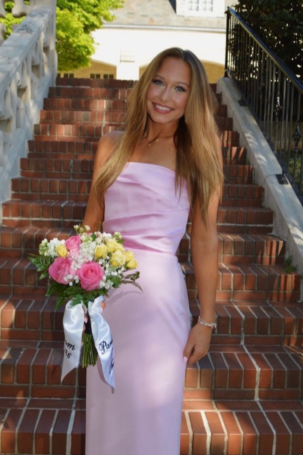 Pink strapless satin fitted gown with ruching.