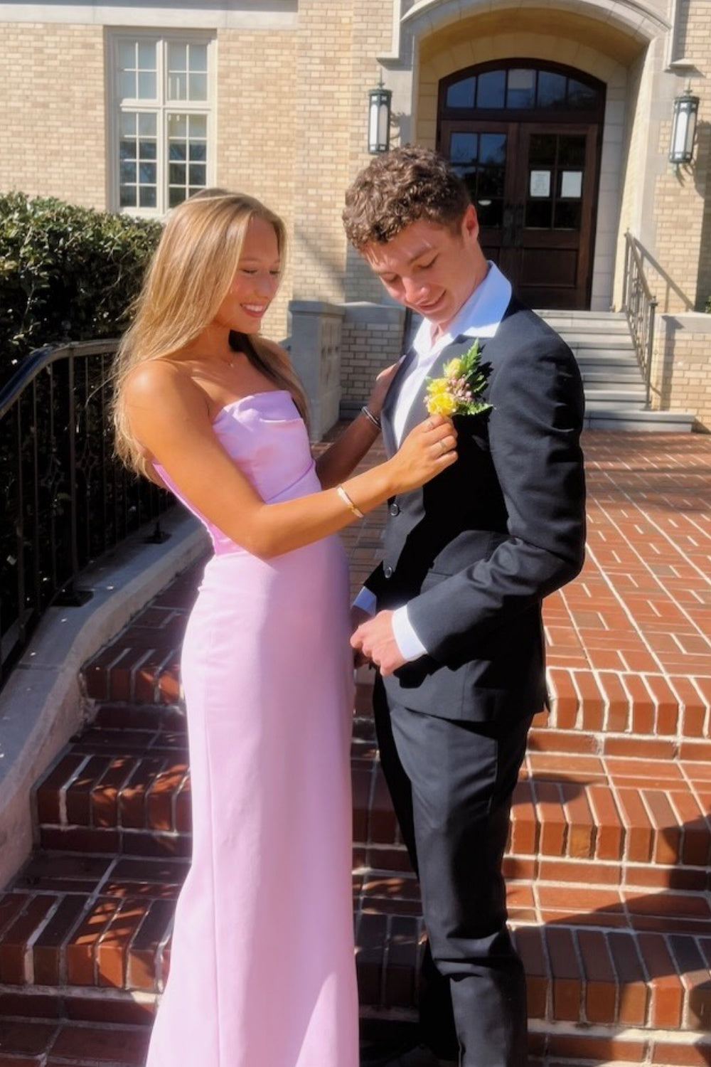 Pink strapless satin fitted gown with ruching.