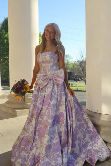 Strapless floral print A-line dress with a bow detail.