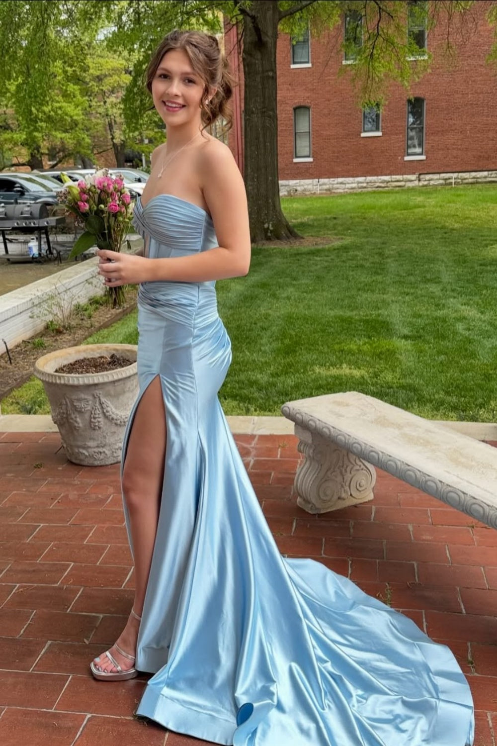 Light blue pleated mermaid dress with side slit and long train.