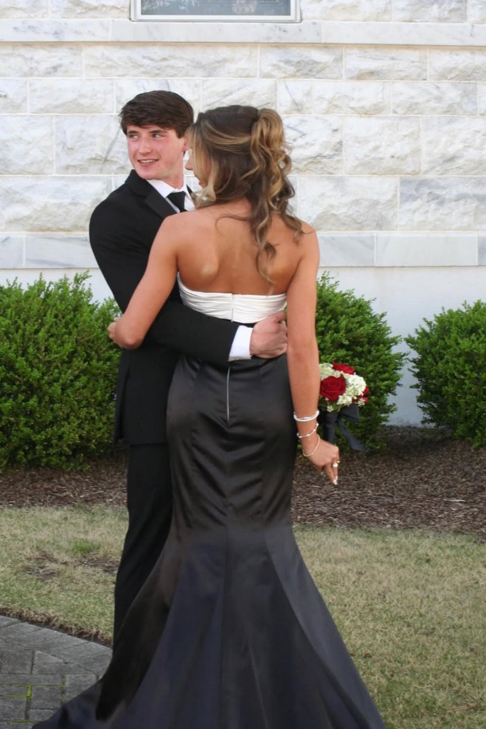 Color-block strapless mermaid prom dress with a large statement bow.