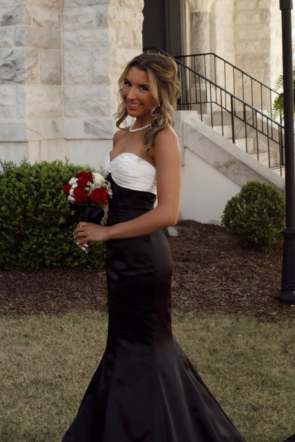 Color-block strapless mermaid prom dress with a large statement bow.