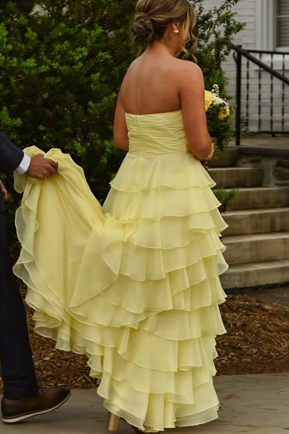 Sunny yellow strapless chiffon A-line prom dress with tiered layers, ruching, and bow detail.