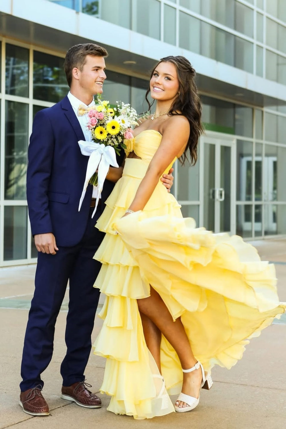 Vibrant yellow sleeveless cut-out bow A-line ruffle prom dress.