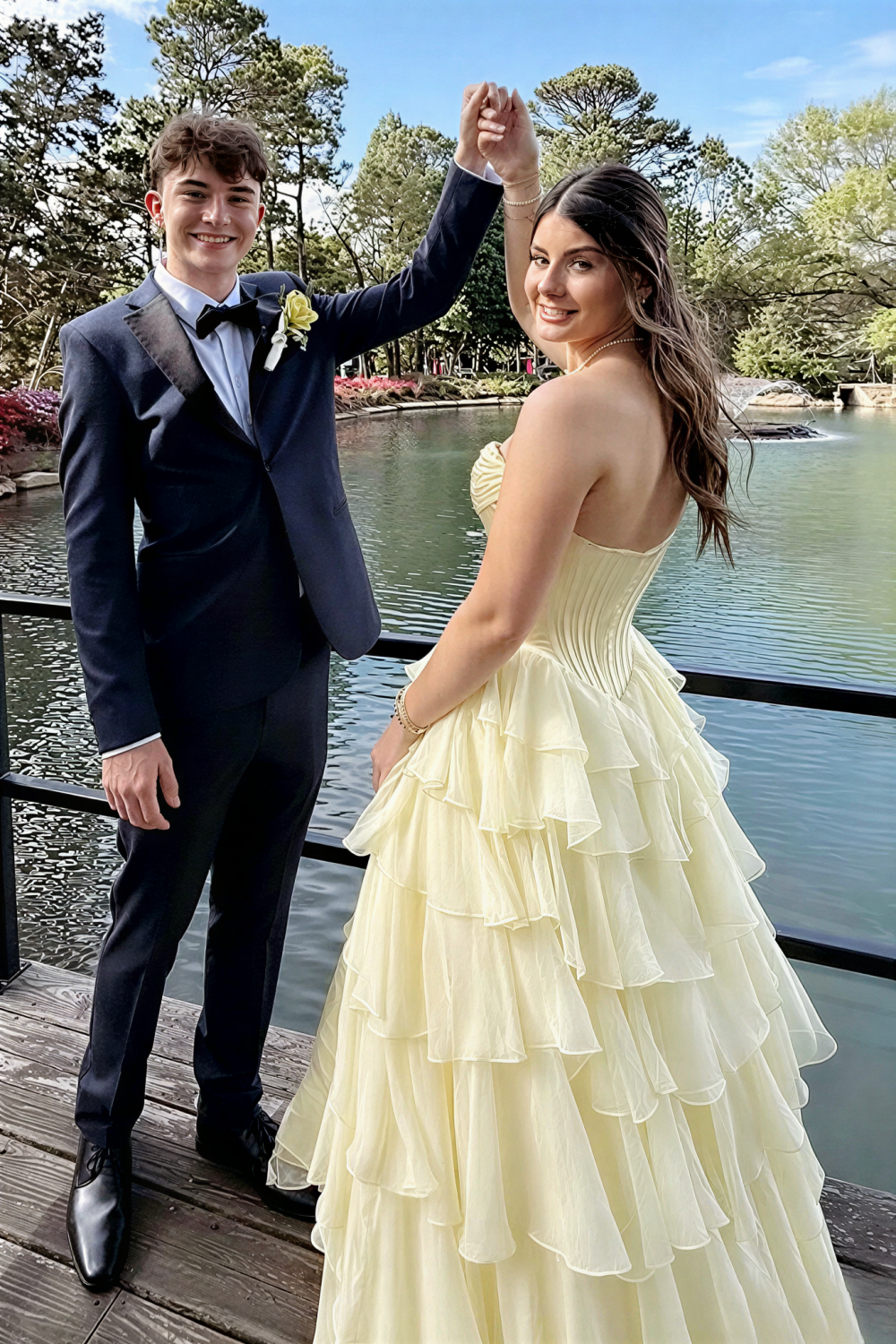 Chiffon corset yellow A-line tiered prom dress with side slit and bow.