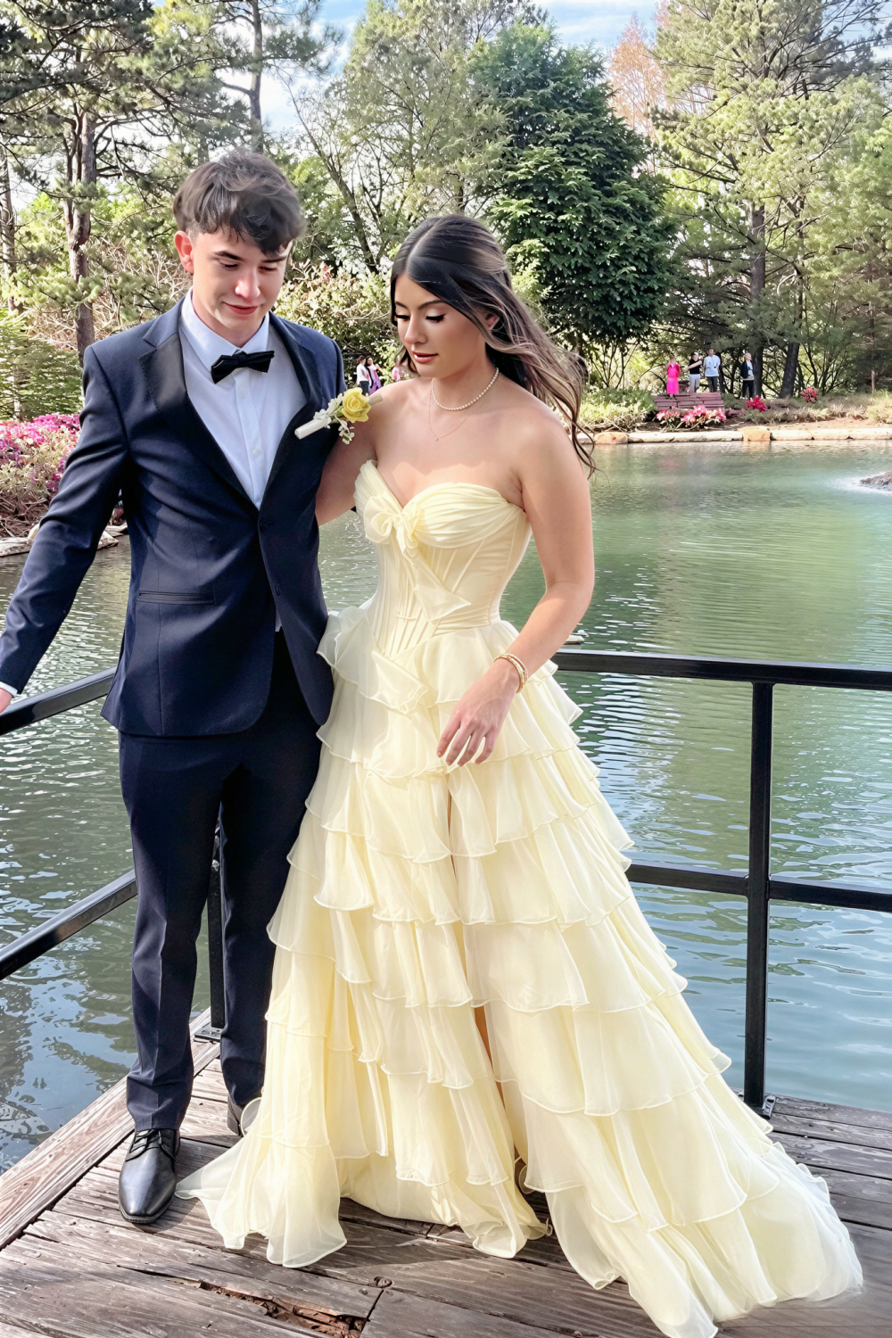 Chiffon corset yellow A-line tiered prom dress with side slit and bow.