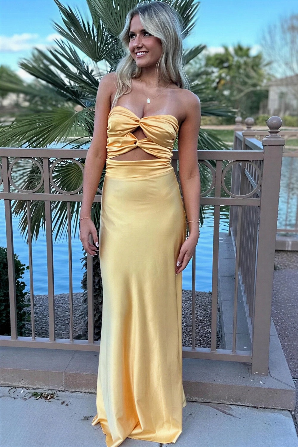 fitted yellow evening gown with twisted chest and keyhole detail