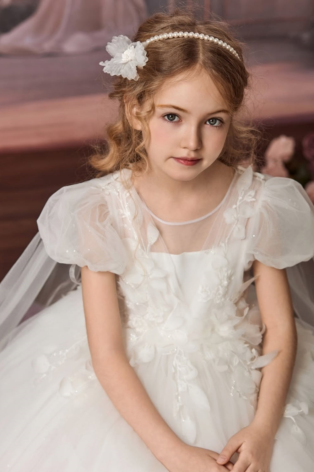 White A-line tulle flower girl dress with 3D floral appliques and cape train.