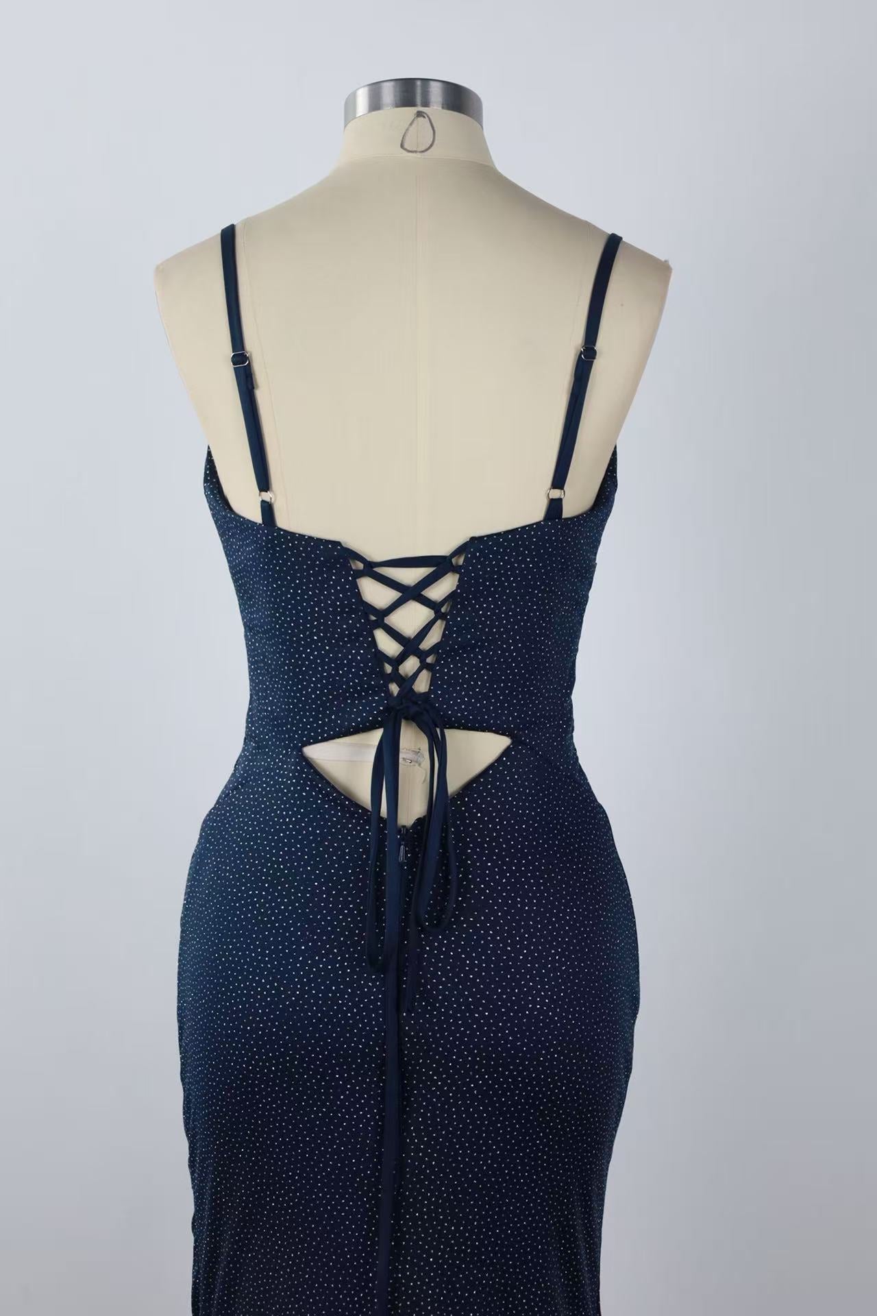 Beaded mermaid prom dress with spaghetti straps, keyhole detail, and side slit.