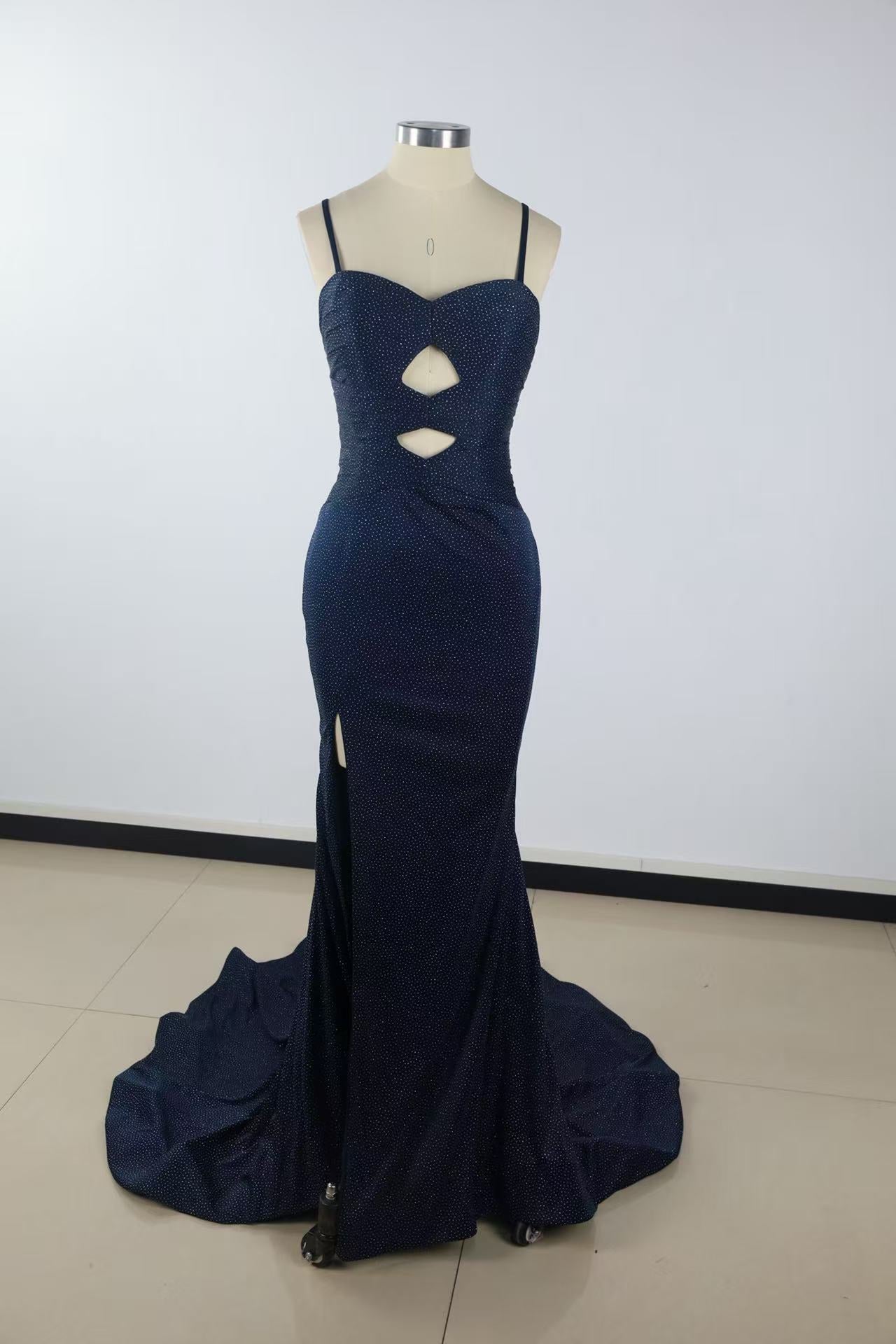 Beaded mermaid prom dress with spaghetti straps, keyhole detail, and side slit.